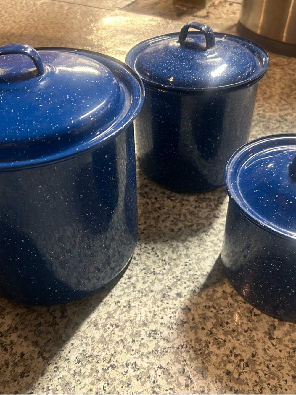 Set of 3 vintage blue speckled enamelware pots with lids.